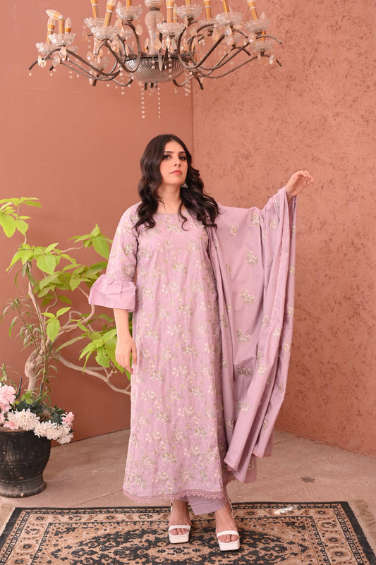 Woman wearing embroidered lilac 3-piece suit with floral embroidery and matching dupatta indoors